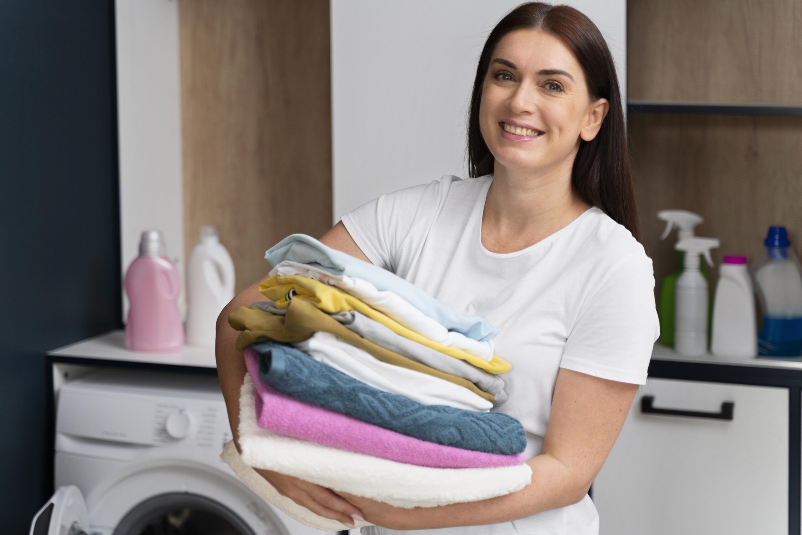 Woman holding freshly cleaned clothes